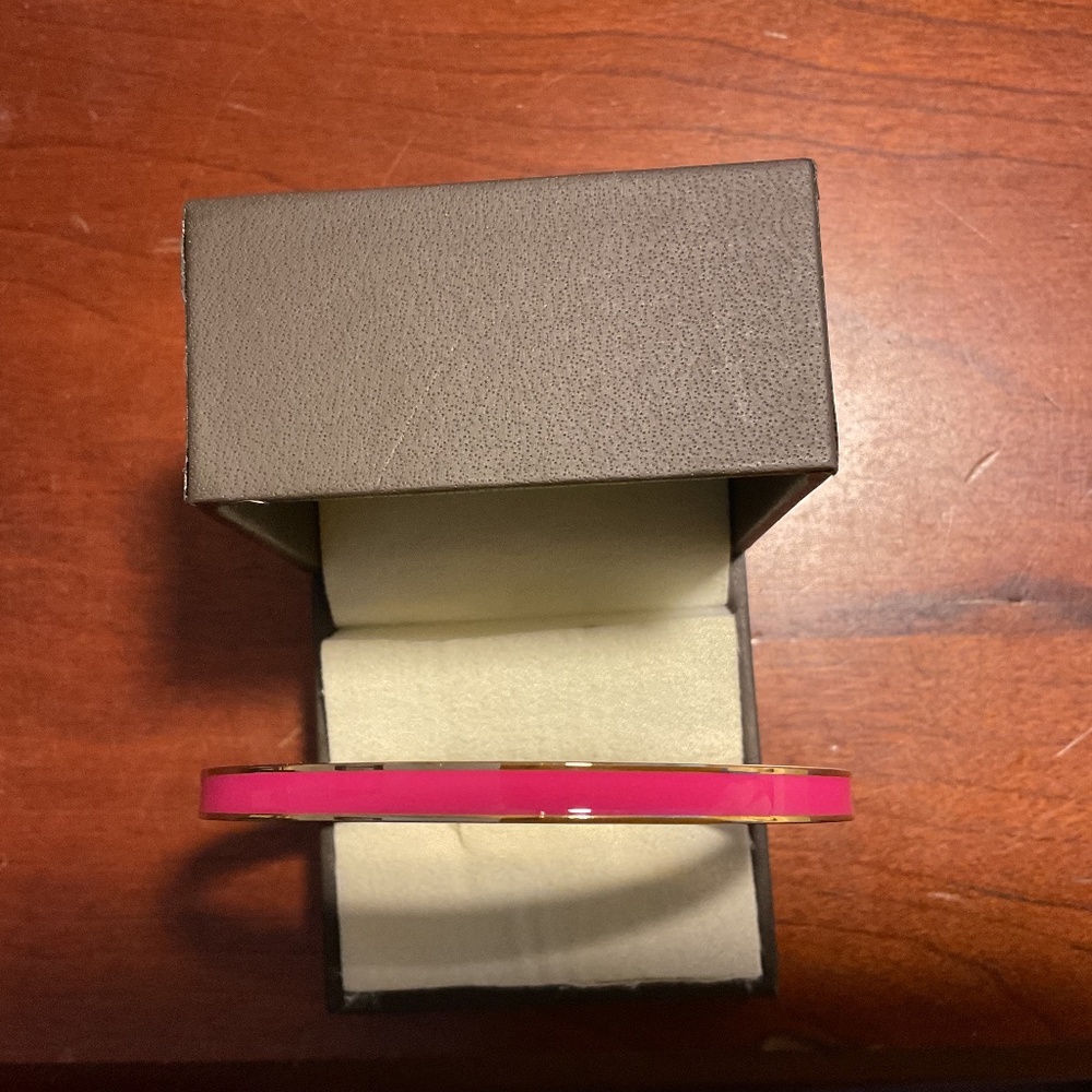 Vintage Kate Spade New York yellow gold tone pink bangle bracelet.